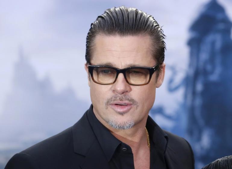 447496-actor-brad-pitt-arrives-for-a-maleficent-costume-display-at-kensington